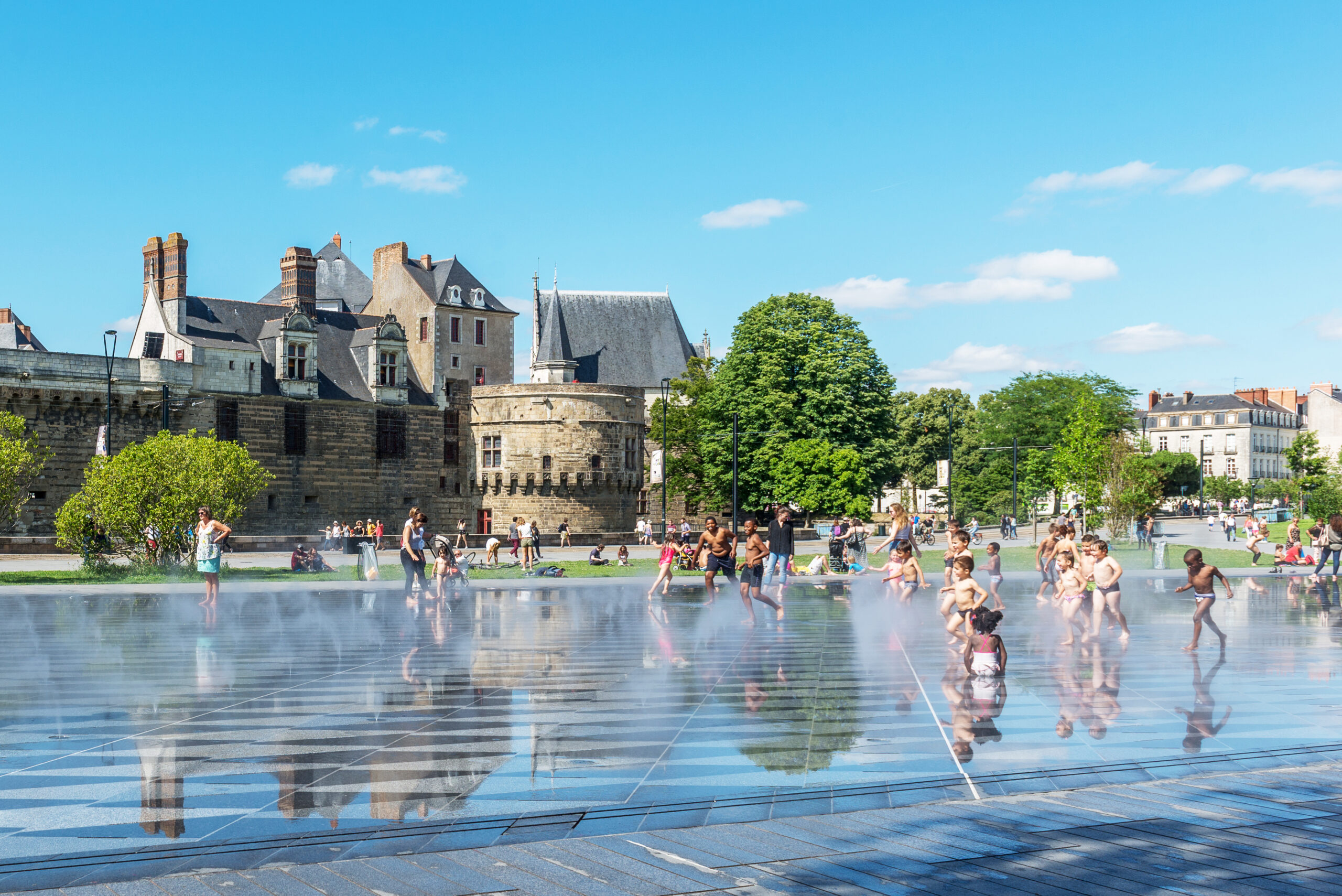 Children play in the fountain in front of the fortress in Nantes, France.