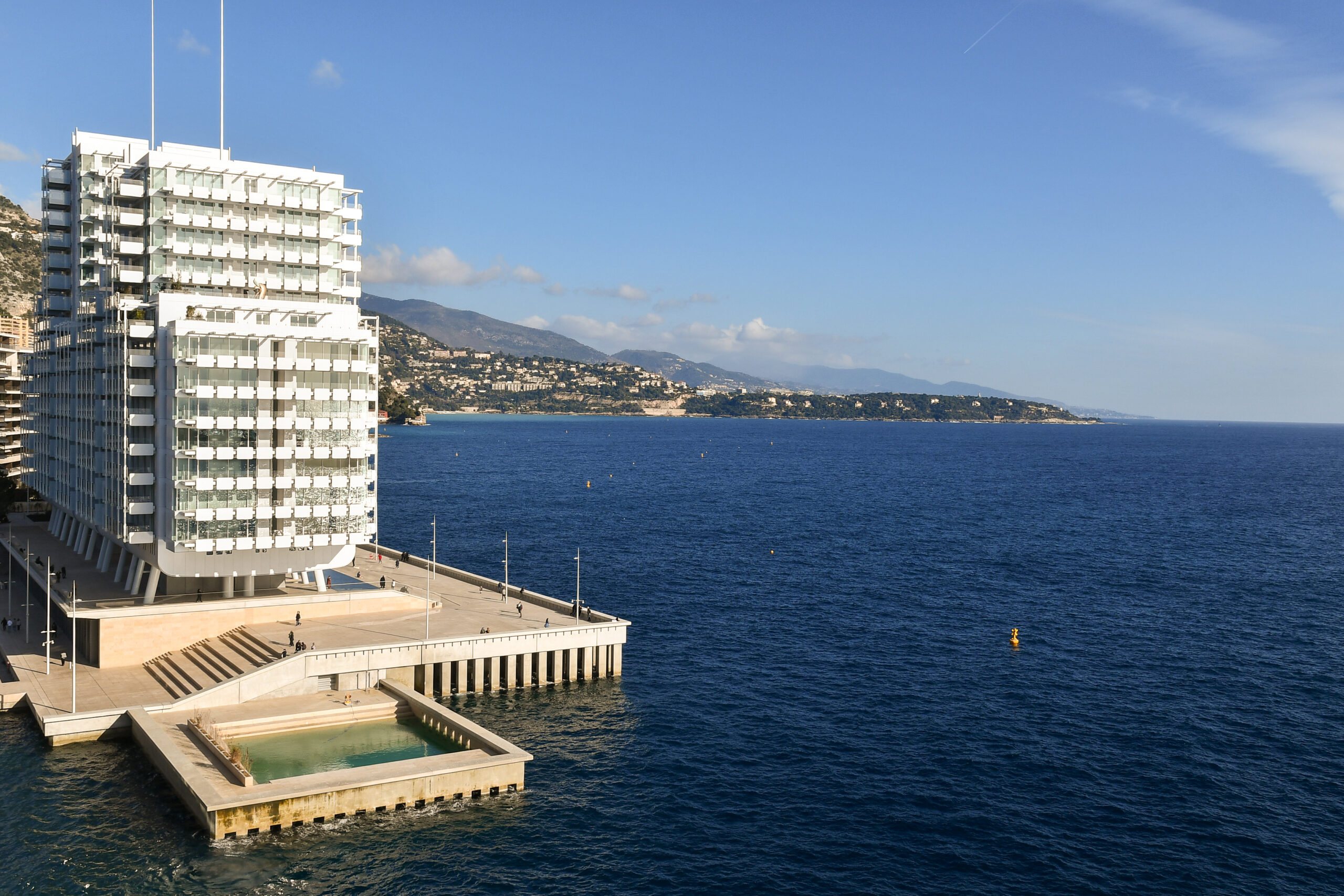 Elevated view of Le Portier, also know as Portier Cove or Mareterra, a residential area built entirely on reclaimed land (2024), with the promontory of Cap Martin in the background, Monte Carlo, Monaco